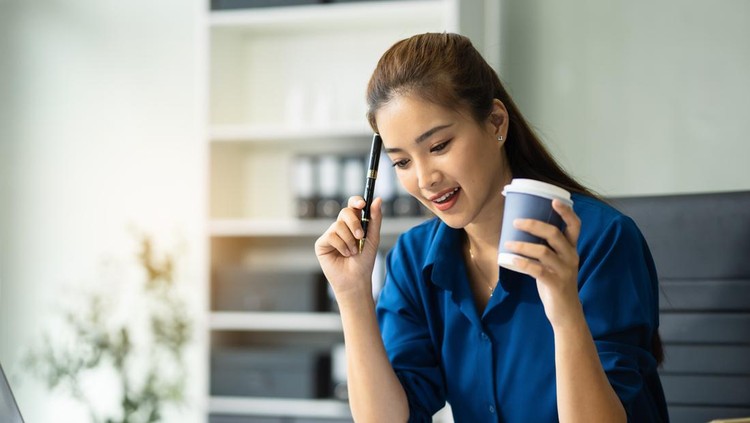 Portrait of woman thinking and looking outside the window during working day at  office.