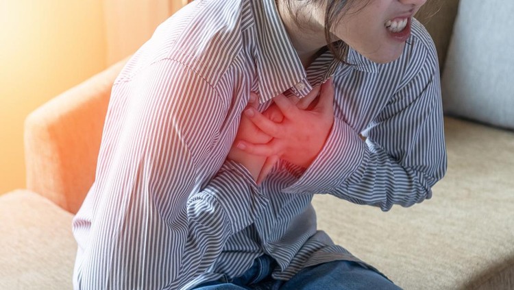 Chest pain illness causing heart attack and stroke&comma; cardiac disease risk in young woman&comma; atrial fibrillation awareness month&comma; heartburn or cardiovascular heart health illness problem