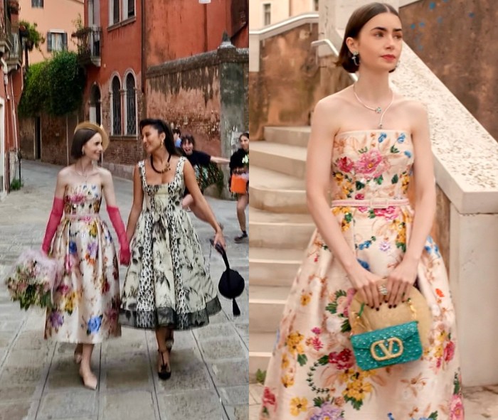 Di episode Veni, Vidi, Venezia, Emily Cooper terlihat bersama Mindy Chen tampil kompak mengenakan dress motif floral. Emily tampak memakai floral dress model strapless sambil menenteng sebuah handbag bernuansa warna turquoise yang dihiasi aksen jewelled dari Valentino./ Foto: Instagram.com/lilyjcollins, Dok. Netflix