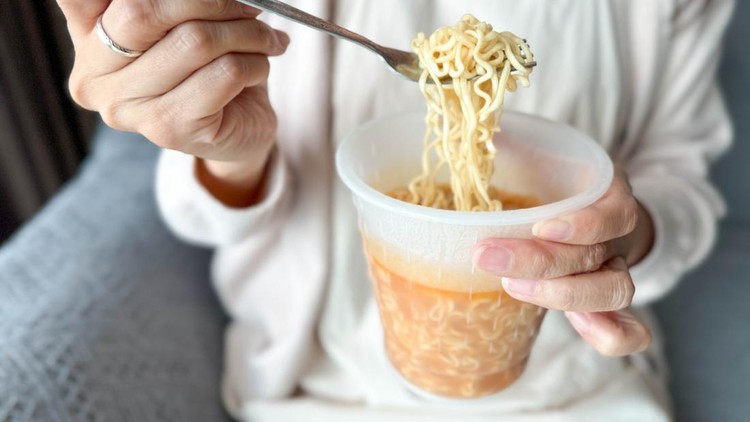 A cozy moment at home as hot steam rises from a bowl of instant noodles&comma; bringing warmth and comfort after a long day&period;