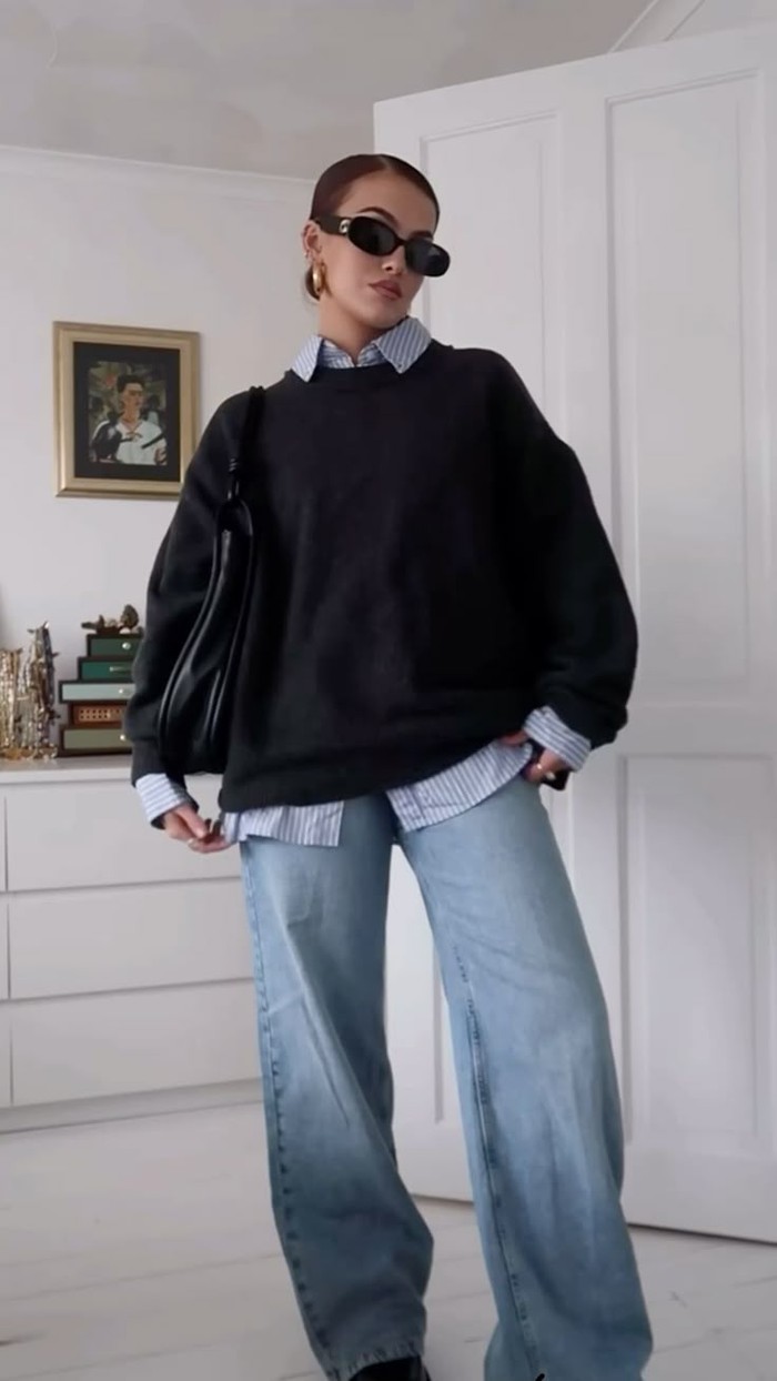 Wide leg jeans dipadukan dengan kemeja dan sweater oversized memberikan kesan effortless namun tetap fashionable. Teknik layering membuat outfit terlihat lebih stylish./ Foto: pinterest.com/ellissaz