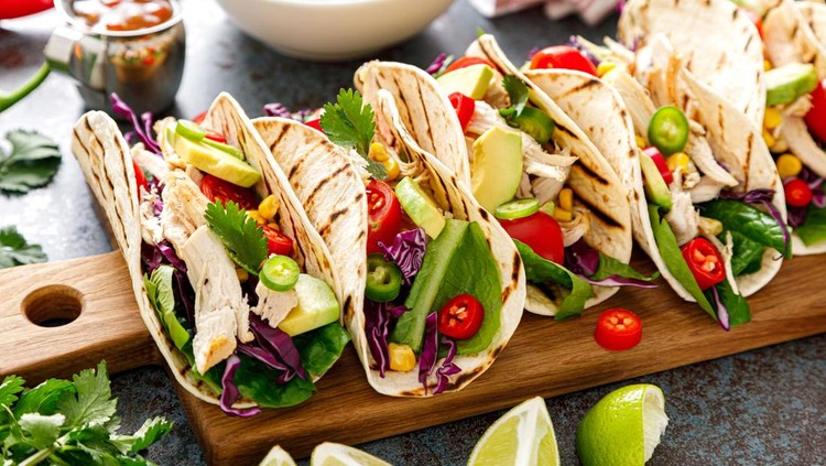 Chicken tacos with grilled meat&comma; avocado&comma; fresh vegetable salad and sauce salsa