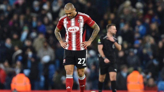 Pemain Exeter City, Josh Magennis, senang timnya kembali fokus ke League One setelah kalah 1-10 dari Man City di Piala FA.