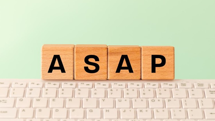 The word ASAP As soon as possible&comma; Internet abbreviation used in communication&comma; e&period;g&period; in business&comma; The inscription on wooden blocks against the background of a computer keyboard