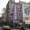 A photograph shows an anti-US and anti-Israel banner hanging on a building in Palestine Square in Tehran on January 27, 2026. A US naval strike group led by an aircraft carrier has deployed to Middle Eastern waters, the United States said on January