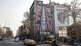 A photograph shows an anti-US and anti-Israel banner hanging on a building in Palestine Square in Tehran on January 27, 2026. A US naval strike group led by an aircraft carrier has deployed to Middle Eastern waters, the United States said on January
