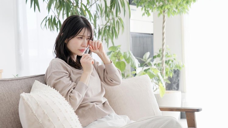 Woman crying in the living room