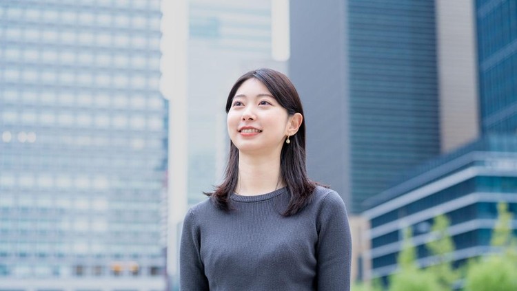 A young Japanese woman smiling in the office district