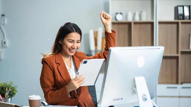 Asian business woman are excited business success with inspiration from their excellent financial results that are happy working in a modern office on a computer&period;