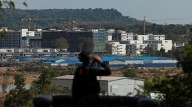 A Thai soldier stands guard near scam compounds, which the Thai military said were used for scam operations in the O'Smach area at the Chong ChomO'Smach border crossing, following clashes between Thailand and Cambodia along a disputed border area, in