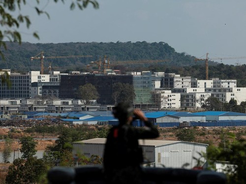 A Thai soldier stands guard near scam compounds, which the Thai military said were used for scam operations in the O'Smach area at the Chong ChomO'Smach border crossing, following clashes between Thailand and Cambodia along a disputed border area, in