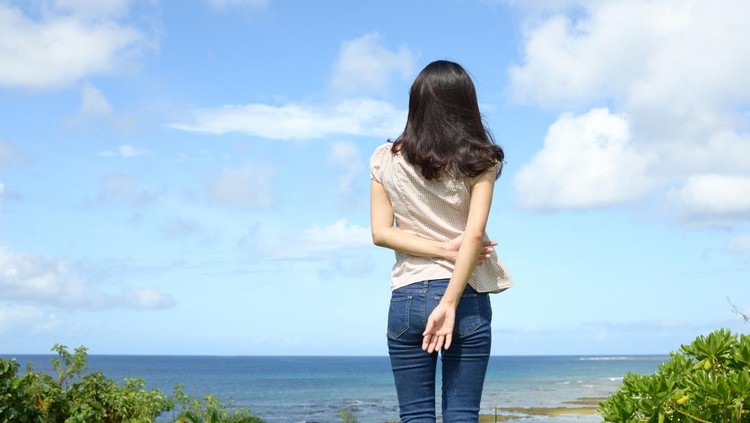 Young woman by the sea