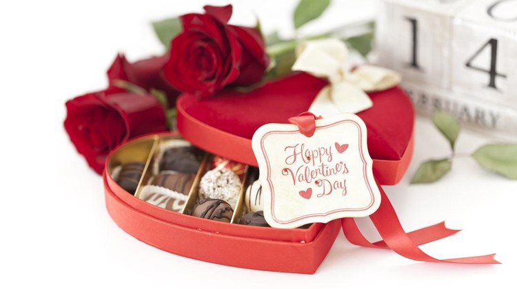 Valentine's Day heart shaped box of chocolates and red roses on white with a gift tag