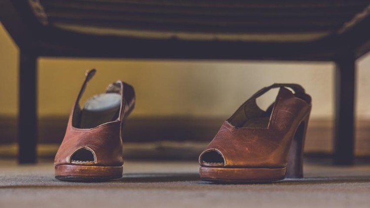 Women's 1930s style shoes disgarded under a bed