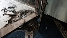 The debris at the doorway of a mosque, which Palestinians say was damaged by Israeli settlers, in West Bank village of Surra, near Nablus in the Israeli-occupied West Bank, February 23, 2026. REUTERS/Mohamad Torokman