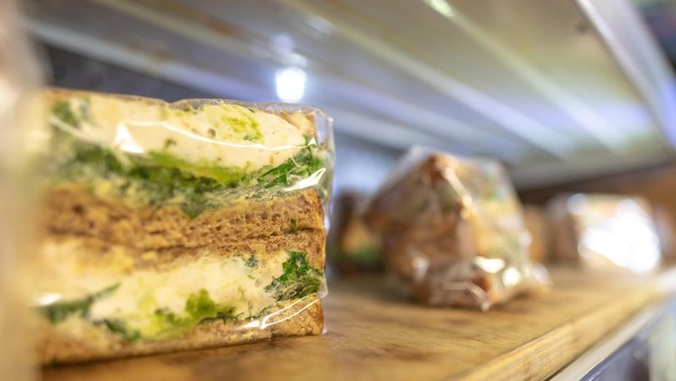 Egg and cress sandwich on a shelf in plastic wrap