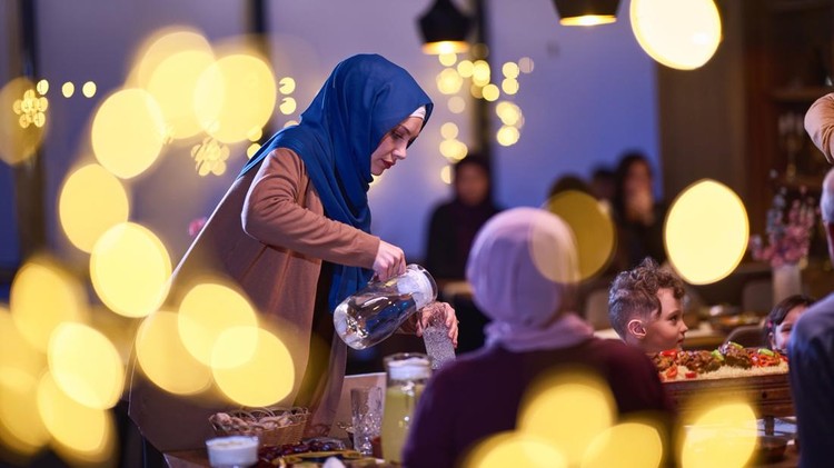 A modern and traditional European Islamic family comes together for iftar in a contemporary restaurant during the Ramadan fasting period&comma; embodying cultural harmony and familial unity amidst a culinary celebration of diversity&period;
