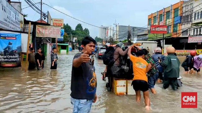 Hujan deras yang mengguyur wilayah Kota Tangerang menyebabkan Jalan KH Hasyim Ashari, Pedurenan, Kota Tangerang, Banten, terendam banjir.