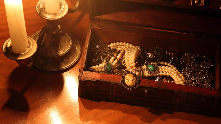 Antique jewelry box&comma; with golden and silver rings&comma; earrings&comma; necklaces&comma; with engravings&period;