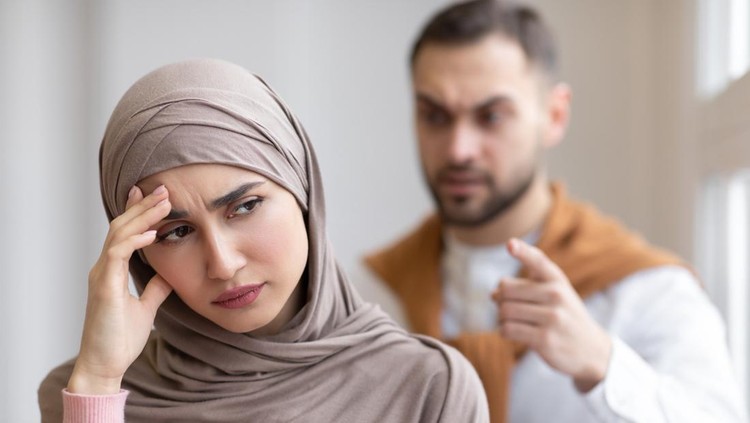 Husband Shouting At Depressed Wife Tired Of Domestic Violence And Victimization Standing At Home&period; Selective Focus&period; Relationship With Abuser And Family Conflicts