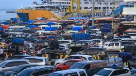 Motorists wait to get on a ferry to travel to Sumatra island, at Merak Port in Cilegon, Banten, on March 18, 2026, as people head to their hometowns for the upcoming Eid al-Fitr festivities which marks the end of the Muslim holy fasting month of Rama
