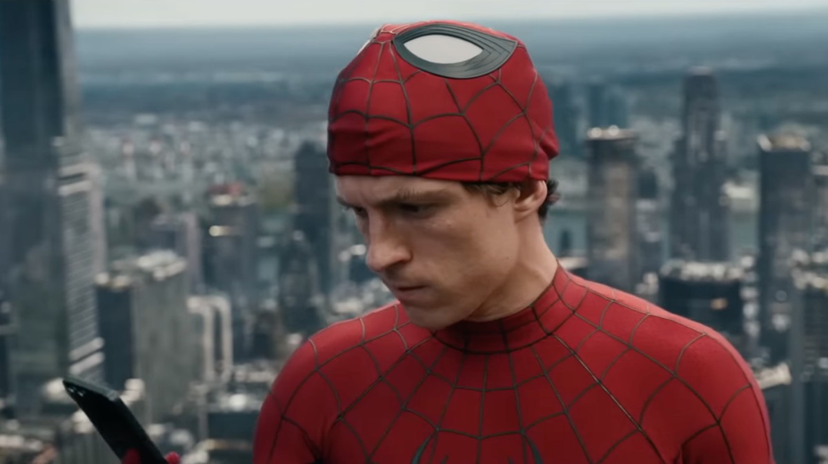 Spider-Man Brand New Day poster displayed in a crowded theater lobby in 2026