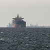 Cargo ships in the Gulf, near the Strait of Hormuz, as seen from northern Ras al-Khaimah, near the border with Omans Musandam governance, amid the U.S.-Israeli conflict with Iran, in United Arab Emirates, March 11, 2026. REUTERS/Stringer REFILE - COR
