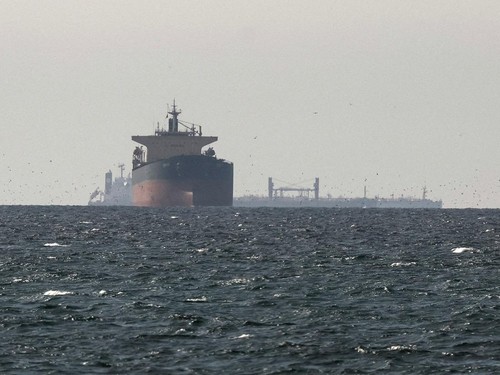 Cargo ships in the Gulf, near the Strait of Hormuz, as seen from northern Ras al-Khaimah, near the border with Omans Musandam governance, amid the U.S.-Israeli conflict with Iran, in United Arab Emirates, March 11, 2026. REUTERS/Stringer REFILE - COR