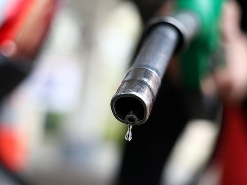 A man holds a fuel nozzle at a petrol station in Paris, France, March 25, 2026. REUTERS/Abdul Saboor