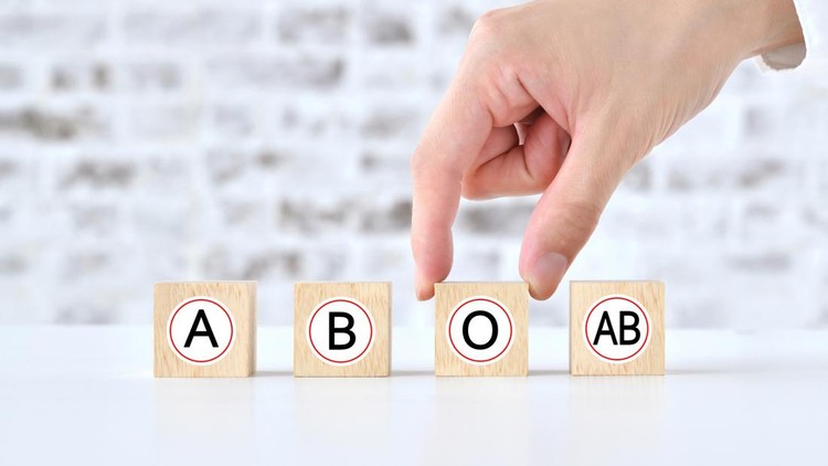 Human's hand picking up wooden blocks with blood type alphabet