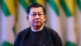 (FILES) Military Chief Min Aung Hlaing looks on after delivering a speech during a memorial event at the Myanmar International Convention Centre (MICC) in Naypyidaw on March 28, 2026, to mark the first anniversary since a 7.7-magnitude tremor struck,