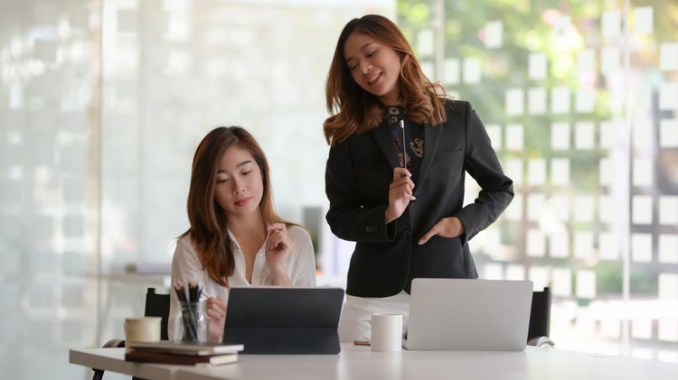 Young professional businesswoman discussing the project together in modern office room