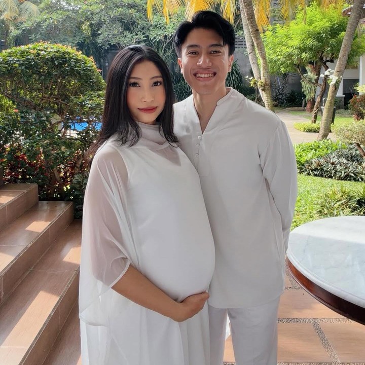 <p>Dalam potret kebersamaan di Hari Raya Idul Fitri, Sangun Ragahdo dan Septiningtyas kompak mengenakan baju bernuansa warna putih. Dalam potret ini, <em>baby bump</em> kehamilan Septiningtyas sudah terlihat jelas. Foto: Instagram @septiningtyas/ @ragahdo)</p>