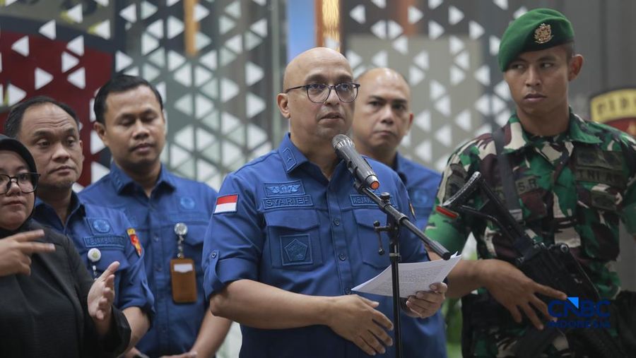 Tersangka kasus korupsi tata kelola minyak mentah melangkah menuju mobil tahanan di gedung Kejaksaan Agung, Jakarta, Kamis (9/4/2026) malam. (CNBC Indonesia/Muhammad Sabki)