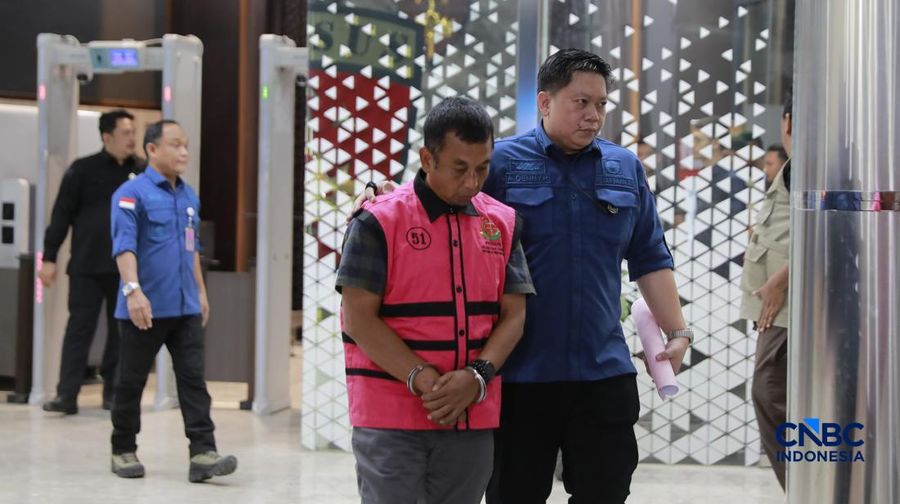 Tersangka kasus korupsi tata kelola minyak mentah melangkah menuju mobil tahanan di gedung Kejaksaan Agung, Jakarta, Kamis (9/4/2026) malam. (CNBC Indonesia/Muhammad Sabki)