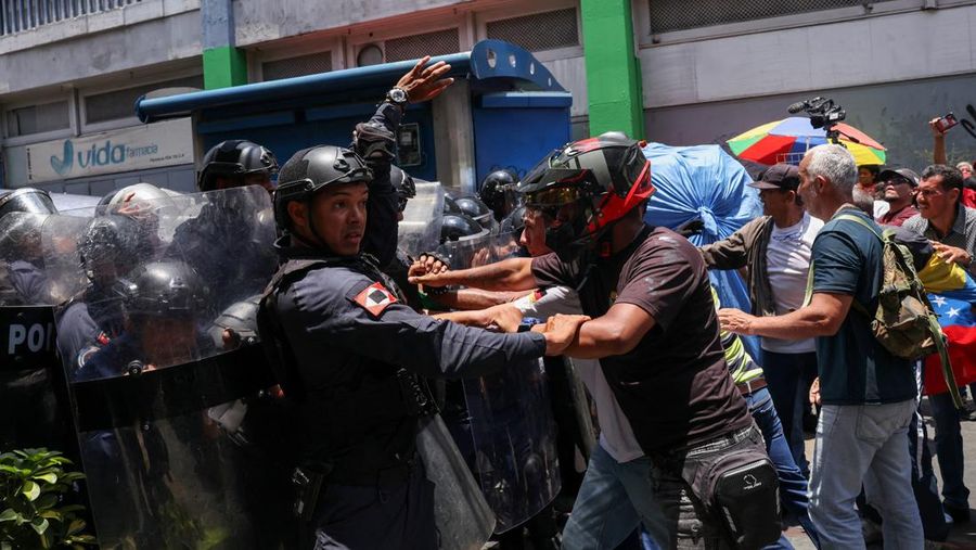 Para pekerja sektor publik berantem dengan Kepolisian Nasional Bolivarian selama protes nan menuntut bayaran lebih tinggi dan kondisi kerja nan lebih baik, di Caracas, Venezuela, 9 April 2026. (REUTERS/Leonardo Fernandez Viloria)