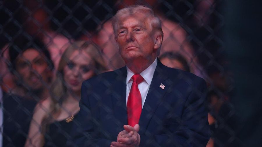 U.S. President Donald Trump and Hunter Campbell, chief business officer of the UFC, watch a match during the UFC 327 event at Kaseya Center in Miami, Florida, U.S., April 11, 2026.  REUTERS/Kevin Lamarque