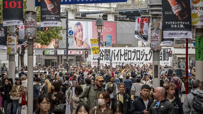 People walk through Shibuya area in Tokyo on April 7, 2026. (Photo by Yuichi YAMAZAKI / AFP)