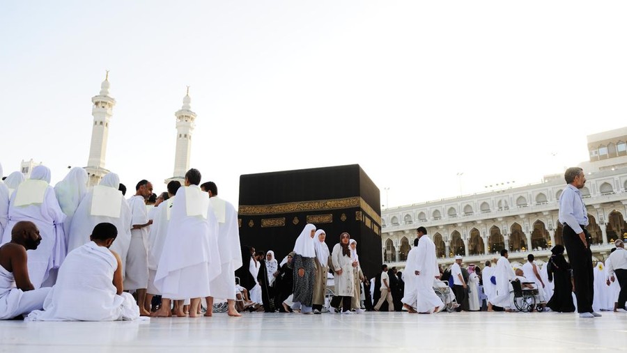 muslim pilgrims wife and husband wearing white traditional clothes for Ihram ready for Hajj