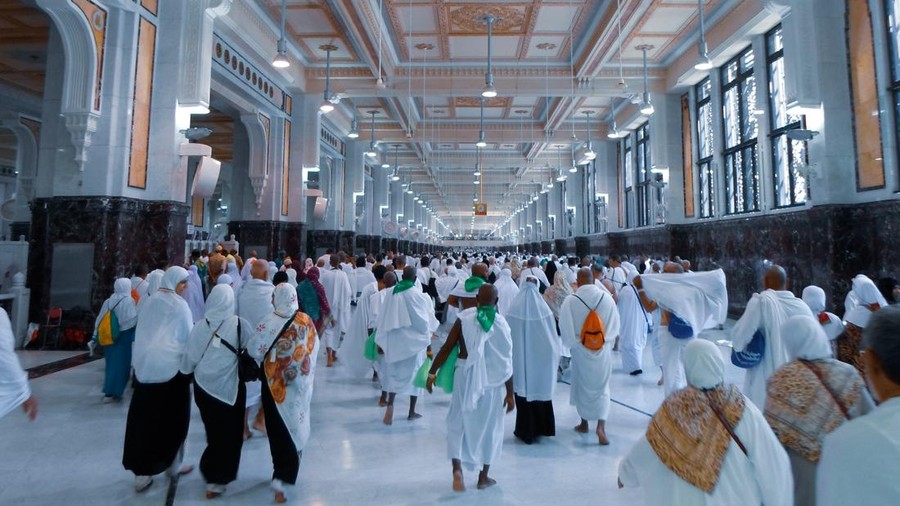 muslim pilgrims wife and husband wearing white traditional clothes for Ihram ready for Hajj