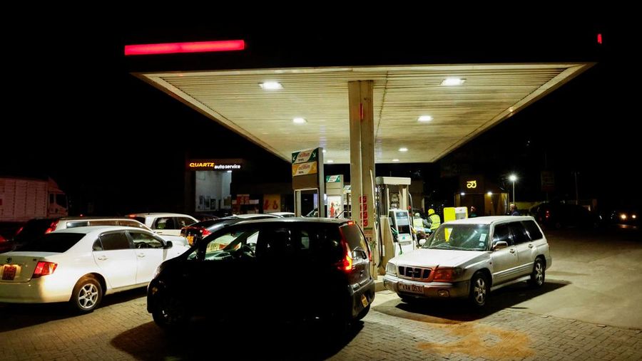 A fuel pump attendant confirms a mobile phone payment as he fuels a motorcycle taxi at a TotalEnergies petrol station ahead of an announced fuel price hike, as fuel costs rise amid dunia disruptions caused by the Iran war, in Nairobi, Kenya April 14, 2026. REUTERS/Thomas Mukoya