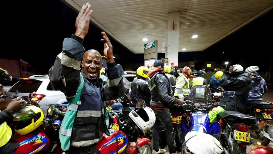 A fuel pump attendant confirms a mobile phone payment as he fuels a motorcycle taxi at a TotalEnergies petrol station ahead of an announced fuel price hike, as fuel costs rise amid dunia disruptions caused by the Iran war, in Nairobi, Kenya April 14, 2026. REUTERS/Thomas Mukoya