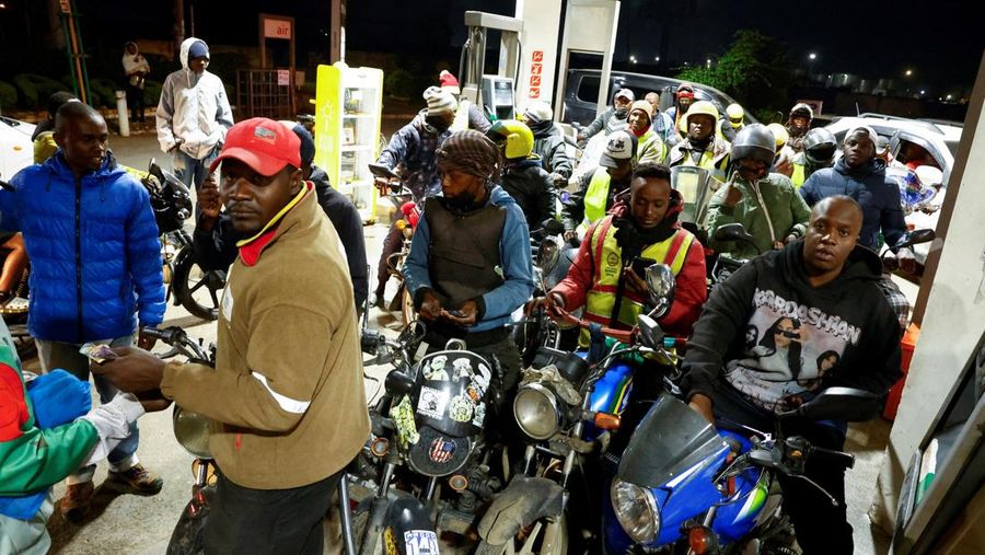 A fuel pump attendant confirms a mobile phone payment as he fuels a motorcycle taxi at a TotalEnergies petrol station ahead of an announced fuel price hike, as fuel costs rise amid dunia disruptions caused by the Iran war, in Nairobi, Kenya April 14, 2026. REUTERS/Thomas Mukoya