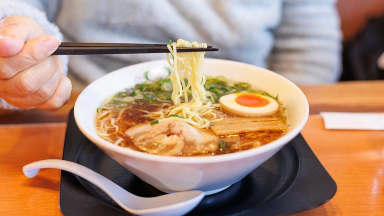 picking soy sauce ramen with chopsticks