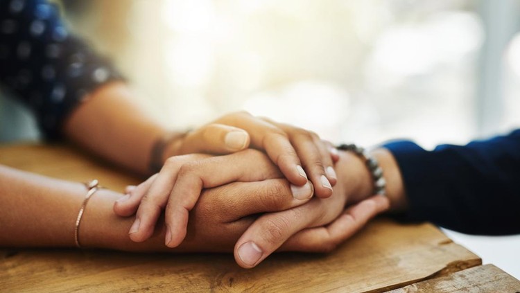 Closeup shot of two unrecognizable people holding hands in comfort