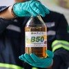 A laboratory technician poses for a picture as he holds a bottle of palm biodiesel 50% fuel during a B50 testing event, as Indonesia plans to raise the mandatory blending rate for palm-based biodiesel from 40% to 50%, a standard known as B50, that is