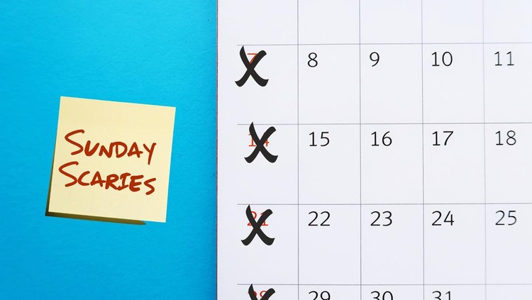 Calendar on blue background crossing on Sunday with stick note SUNDAY SCARIES &lpar;Sunday blues&rpar; - feelings of intense anxiety or dread happen on day before head back to work&comma; office or school - the week ahead nervousness