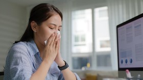 Asia people young lady remote workforce work on leave day got bad cold flu covid cough blow running nose on tissue paper sit on desk at home office. Tired unwell female freelance staff stress pain.
