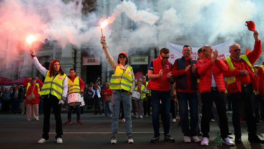 Sejumlah massa menyalakan suar alias flare saat menghadiri seremoni Hari Buruh tradisional di Wina, Austria, Jumat (1/5/2026). (REUTERS/Elisabeth Mandl)