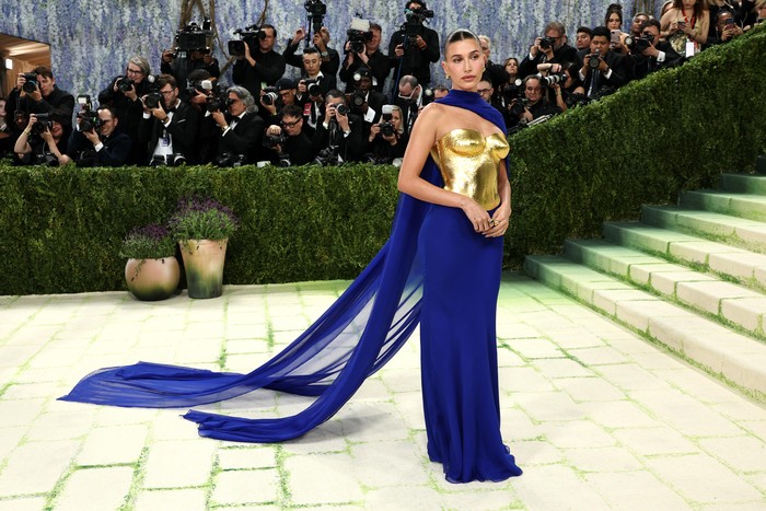 &ldquo;Karya seni&rdquo; yang dipakai Hailey Bieber mengambil inspirasi dari koleksi adibusana Saint Laurent Autumn/Winter 1969 di mana desainer menggandeng seniman dan pemahat Prancis, Claude Lalanne, untuk membuat pahatan breastplate. Sculpted bodice yang dikenakan terbuat dari 24 carat gold, dipadukan dengan chiffon lavalli&egrave;re/ Foto: Courtesy of Saint Laurent